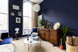 The dark blue walls and earthy fiber carpet were chosen for their ability to encourage unwinding.