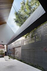A breezy patio features a pitched roof that offers a view of the sky.