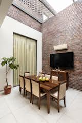 Dining Room, Table, Ceramic Tile Floor, and Wall Lighting  Photo 10 of 26 in The Brick House by Studio Ardete
