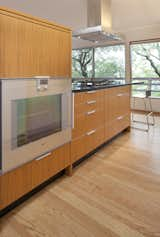 Kitchen, Engineered Quartz Counter, Medium Hardwood Floor, Wood Cabinet, Ceiling Lighting, and Wall Oven Kitchen oven hidden from view  Photos from Sonoma Modern Kitchen