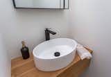 Bath Room, Wood Counter, Light Hardwood Floor, and Vessel Sink Custom white-oak vanity in powder room  Photo 8 of 12 in Modern Urban Treehouse by Denika Jones Almburg