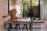 Living Space with lychee slab table & Javier Marin-esque wood bust - natural garden + leafy dianphonous curtains