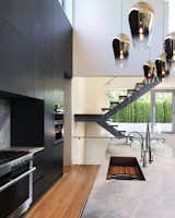 Open kitchen + dining room in a double height space.