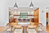 Stools, Table, Chair, Ceiling Lighting, Pendant Lighting, Medium Hardwood Floor, and Kitchen Dining  Photo 1 of 1 in Kitchen by Joshua Dillon