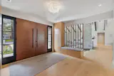 Foyer, custom cabinetry and wood slat screen.