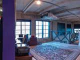 Master bedroom with hidden closet (left) and eastern Biscayne bay views through tinted windows and access to additional mezzanine.