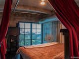 Mezzanine add on currently used as a master bedroom space with a south facing bed with downtown miami framed in the windows for a glorious night view.
