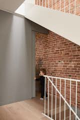 Staircase, Metal Railing, and Metal Tread Powder room hidden under the staircase  Photo 12 of 24 in La maison du petit prince by Alexandre Bernier Architecte