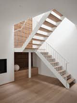 Smooth and light Staircase constrsting the existing lumber wall texture