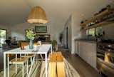 RDS specified simple white Ikea cabinets but upgraded them with a terrazzo countertop to add an organic feel to the surface and connect the kitchen to the stone fireplace in the living room.
