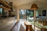 A deceptively simple move was to create an angle in the formerly low, flat ceiling over the kitchen and main living area. While the original trusses weren't appealing enough to expose, there was enough space for the team to insert new trusses in order to vault the ceiling, which lent height and character to the space, giving it the look and feel of a traditional "great room."