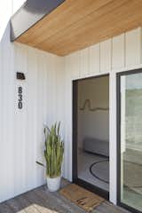 Exterior, House Building Type, Metal Roof Material, and Metal Siding Material A garage entrance leading straight into a mudroom and laundry room is perfect for leaving behind messy belongings.   Photo 2 of 16 in Millbrae House by Red Dot Studio