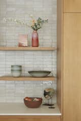 Cle tile is featured in the kitchen with floating white oak shelving.