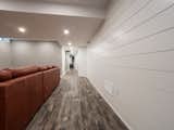 A contemporary Penguin finished basement renovation in Brampton, Ontario that makes the most of a narrow space.