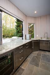 The stainless steel cabinets and appliances in this outdoor kitchen are customized for outdoor use. Because it is an outdoor kitchen, all plumbing is designed to be drained and winterized.