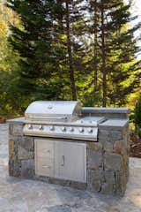 This deluxe professional grill provides amble power to cook for a large group. It includes a side burner, four burners, and storage.