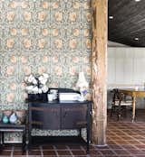 An old log makes for a great divider. Beautiful wallpaper from William Morris