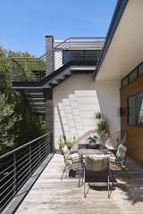 Cantilevered stair to roof deck overlooking patio.