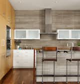 The Kitchen was designed with painted and natural wood finished cabinets.