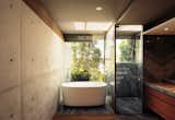 Bath Room, Granite Counter, Medium Hardwood Floor, Soaking Tub, Enclosed Shower, Freestanding Tub, Recessed Lighting, and Concrete Wall  Photos from Caucaso House