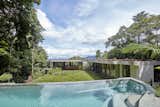 Behind the home, a glade facing northeast offers a protected outdoor oasis set within the rainforest ridge with a magnesium-filtered, above-ground pool.  
