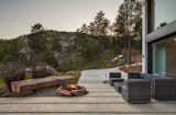 Outdoor, Front Yard, Shrubs, Grass, Hardscapes, Trees, Boulders, Large Patio, Porch, Deck, and Concrete Patio, Porch, Deck Main House Fire Pit  Photos from The Tesla of Boulder Homes Offered at $25,000000