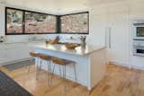 Kitchen, Marble Counter, White Cabinet, Medium Hardwood Floor, Stone Slab Backsplashe, Ceiling Lighting, Undermount Sink, Refrigerator, Wall Oven, Cooktops, and Dishwasher Main House Kitchen  Photo 7 of 17 in The Tesla of Boulder Homes Offered at $25,000000 by Mark Morrison