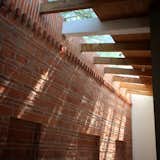 traditional red brick on the main wall iluminated by natural light  Photo 7 of 9 in Casa Guzmán by Julio Gomez Trevilla