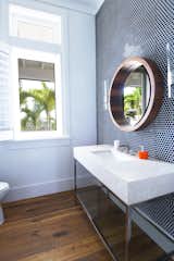 Bath Room, Stone Counter, Medium Hardwood Floor, Undermount Sink, Wall Lighting, Mosaic Tile Wall, and One Piece Toilet Guest Bathroom  Photos from Bahamas Style