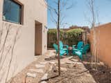 Outdoor, Trees, Landscape Lighting, Horizontal Fences, Wall, Side Yard, Hardscapes, Hanging Lighting, Flowers, and Gardens  Photo 4 of 37 in One Of A Kind Santa Fe Modern Home by Austin