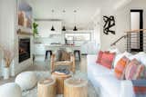 The sunken light flooded living room and kitchen is adjacent to an elevated dining area.