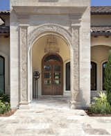 Mediterranean influenced entry way with custom made front door. 