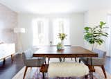 Dining table and bench: custom. Chanel Dining Chairs: Article. Mid-Century Tripod Floor lamp: West Elm. Tejn Faux Sheep Skin: Ikea; Source: Amy Bartlam/Parachute  Photo 5 of 11 in How to Design an Apartment You and Your Roommate Love