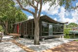 Set on a quiet lane in Siesta Key, this jewel box home measuring about 760 square feet, holds firmly on cantilevered beams that inch over Bayou Louise. The simple layout lends to an uncluttered coastal lifestyle. The catenary roof curves down into the interior to create an intimate space inside while exhibiting historic architectural feats from the outside.