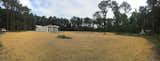 Panorama of cleared space just after mulching new grass seed. 