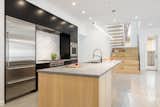 Kitchen, Cooktops, Ceiling Lighting, Range Hood, Refrigerator, Concrete Floor, Recessed Lighting, Marble Counter, Undermount Sink, Wall Oven, Wood Cabinet, Pendant Lighting, and Marble Backsplashe  Photo 7 of 18 in Hyde Park House by Studio MM Architect