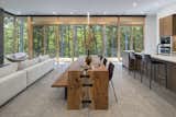Dining Room, Table, Pendant Lighting, Accent Lighting, Concrete Floor, Chair, Ceiling Lighting, and Bench  Photo 12 of 28 in Cat Hill by Studio MM Architect