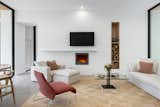 Living Room, Sofa, Recessed Lighting, Wood Burning Fireplace, Chair, Concrete Floor, Bookcase, and Standard Layout Fireplace  Photo 3 of 17 in Kaat Cliffs by Studio MM Architect