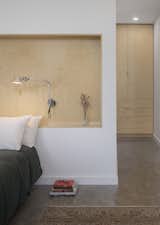 Bedroom, Night Stands, Accent Lighting, Concrete Floor, Bed, Wall Lighting, Shelves, Dresser, and Recessed Lighting  Photo 7 of 17 in Kaat Cliffs by Studio MM Architect
