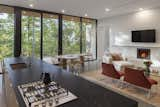 Dining Room, Ceiling Lighting, Chair, Concrete Floor, Table, Wood Burning Fireplace, Recessed Lighting, and Standard Layout Fireplace  Photo 15 of 17 in Kaat Cliffs by Studio MM Architect