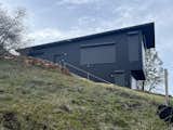 Exterior, House Building Type, Metal Siding Material, Shed RoofLine, Cabin Building Type, and Metal Roof Material Metal shutters protect the openings in case of fire   Photo 4 of 7 in 8 One X Off Grid House by Hart Wright Architects