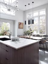 Kitchen, Marble Counter, Cooktops, Pendant Lighting, Wood Cabinet, Ceramic Tile Backsplashe, Limestone Floor, Undermount Sink, and Refrigerator Kitchen has elements of the Victorian with modern detailing  Photo 4 of 7 in San Francisco Victorian Remodel by Hart Wright Architects