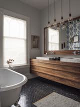 Bath Room, Stone Counter, Limestone Floor, Vessel Sink, Enclosed Shower, Recessed Lighting, Wood Counter, One Piece Toilet, Freestanding Tub, and Stone Tile Wall The mix of modern and Victorian with a natural wood vanity  Photo 6 of 7 in San Francisco Victorian Remodel by Hart Wright Architects