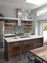 Kitchen, Marble Counter, Wood Cabinet, Limestone Floor, Pendant Lighting, Cooktops, Range, Undermount Sink, Refrigerator, and Ceramic Tile Backsplashe Modern details with elements from the traditional Victorian  Photo 7 of 7 in San Francisco Victorian Remodel by Hart Wright Architects