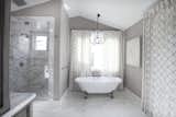 The ultimate bathroom coated in Calcutta Marble with book matched shower walls and slipper tub.