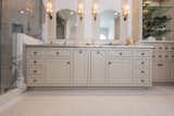 Master bath cabinetry makes a statement with the symmetry and custom hand-beaded inset doors.