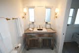Vintage marble sink and brass lanterns complete this very special beach house getaway bathroom.