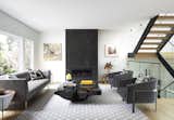 Expansive windows and an open staircase pull in light throughout. 