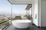 The oval tub in the master bath, perched in a corner, provides exceptional city views.