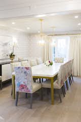 The bright dining room hosts a 10' marble and brass table perfect for large family gatherings.